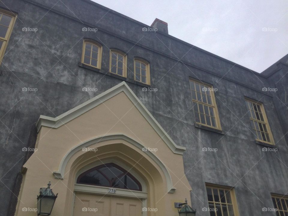 The windows and doorway of an old brick building 