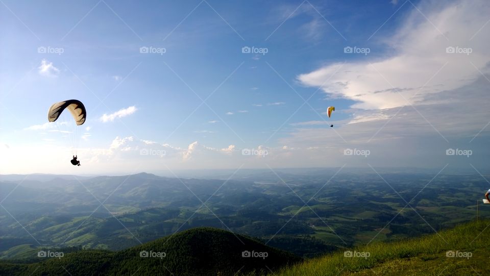 high mountais hills gliders landscape nature sky clouds paraglider parachute green village country town city view brazil south america place minas gerais fly flying sport adventure adrenaline action travel location