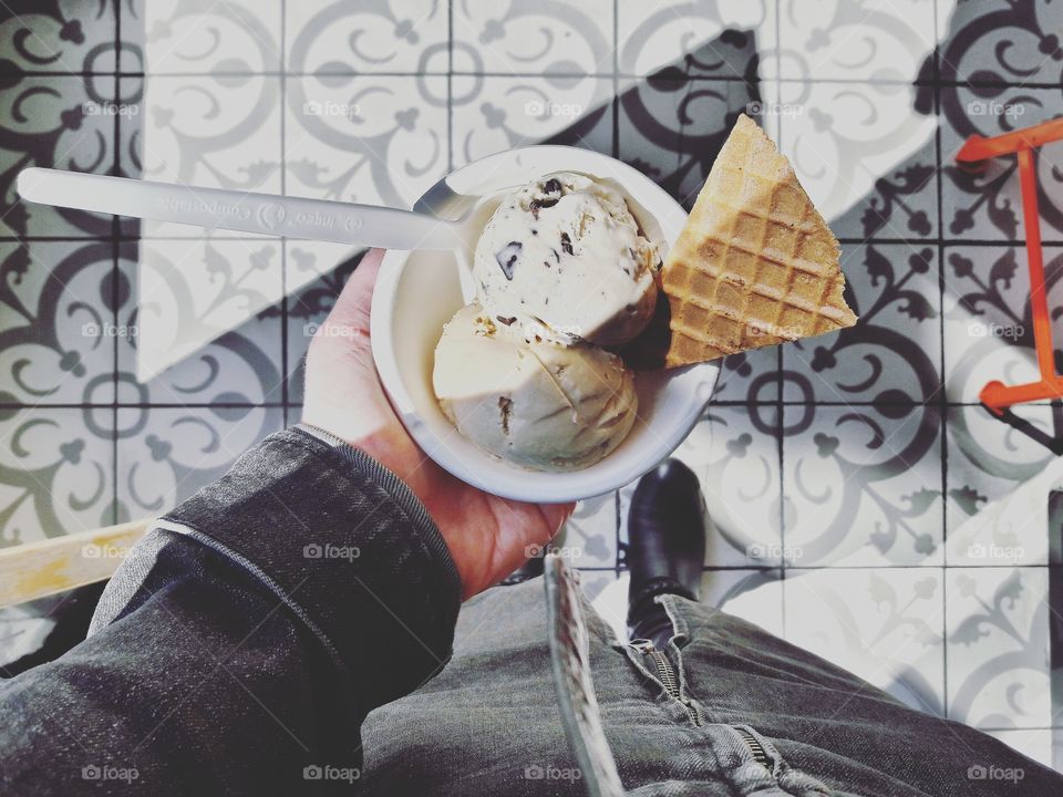 High angle view of man holding scoop ice cream