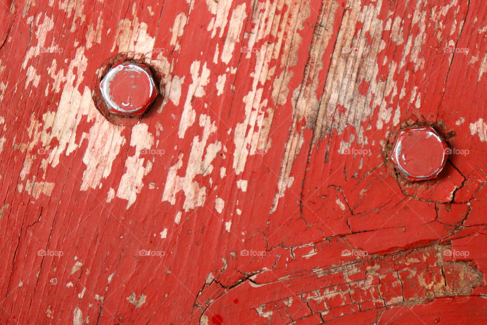 Full frame of peeling red paint and nails