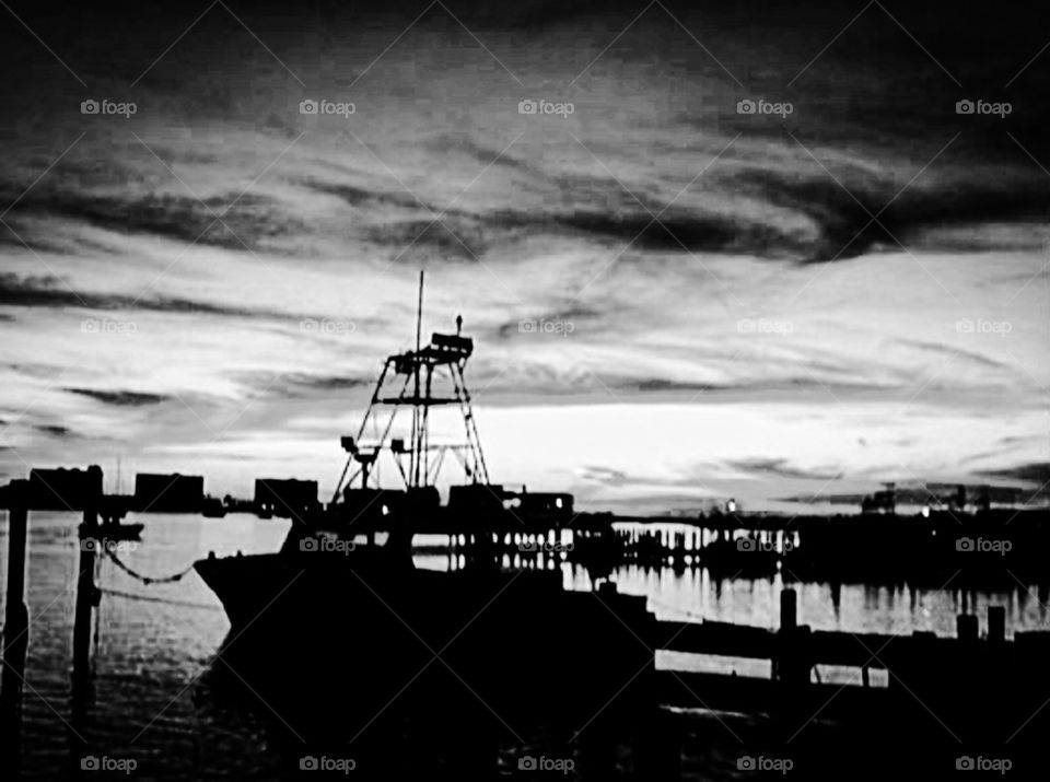 Boat black and white. This is a black and white sunset over the bayou near by