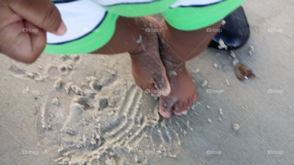 baby feet in beach sand