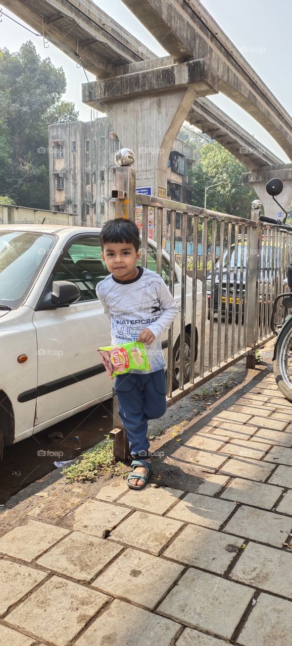 Cute Indian Kid👲
Standing beside the Railing
 Chips in Hand
Dev gujjar