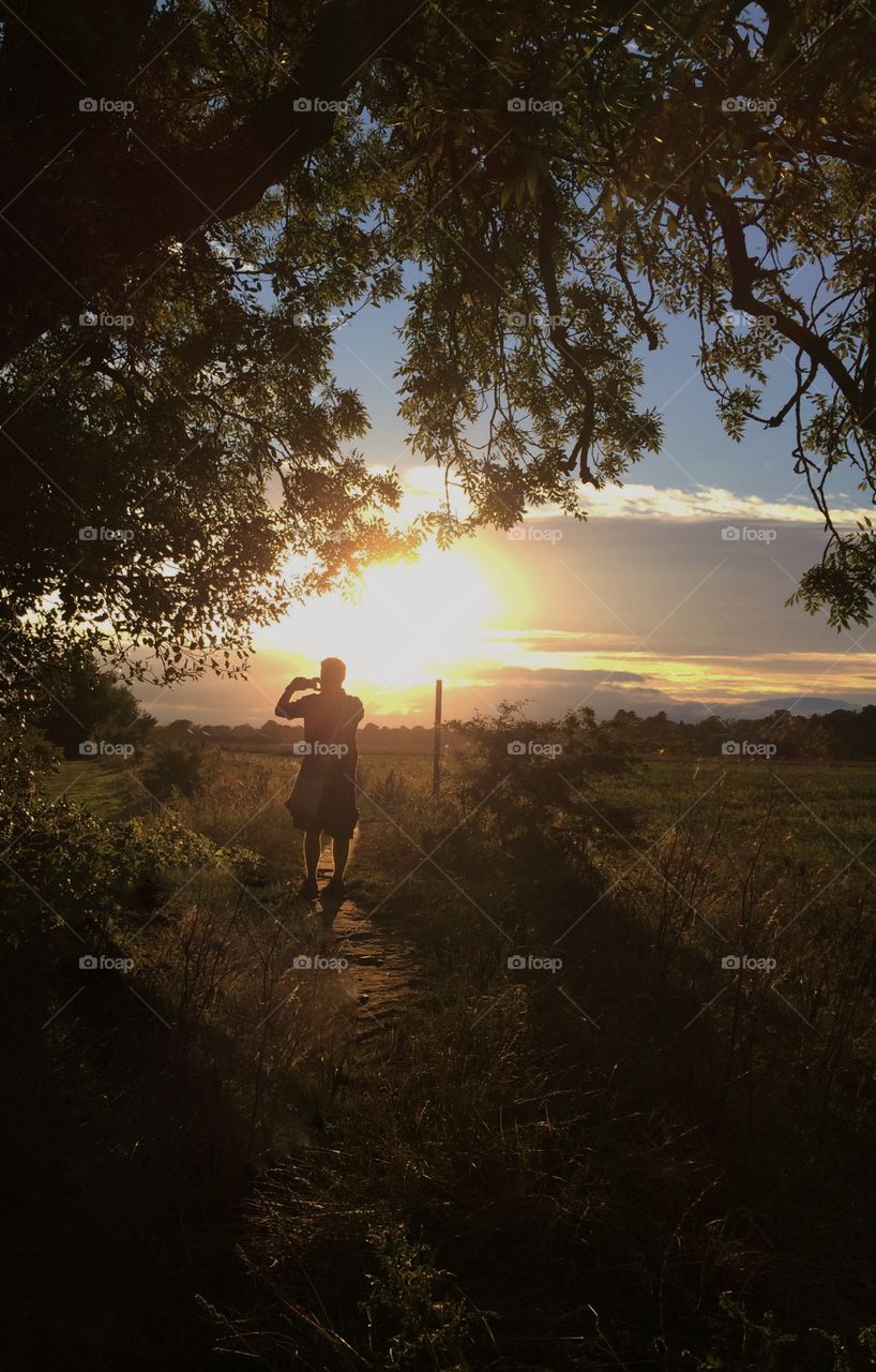 A Complete Stranger. I took a photo of a complete stranger taking a photo during golden hour ...