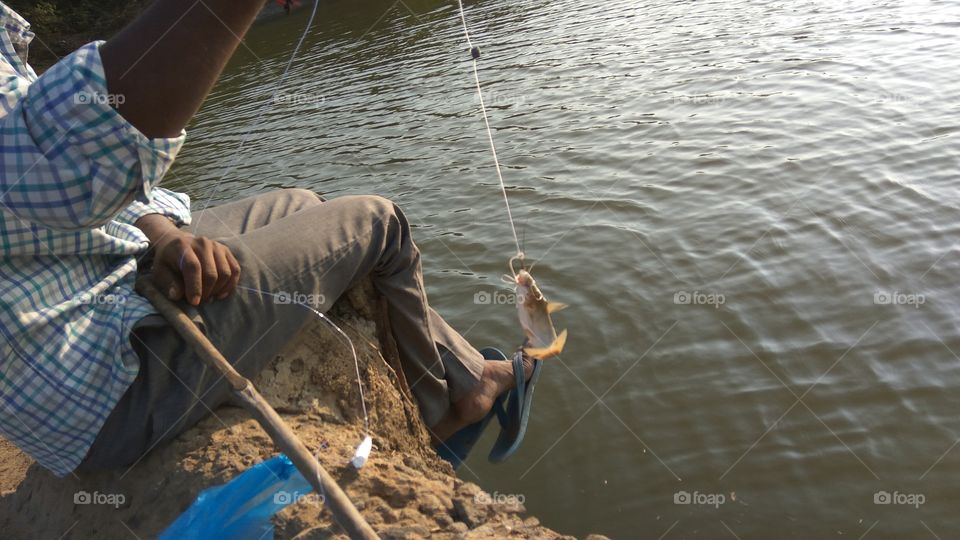 the fisher man is catching a fish