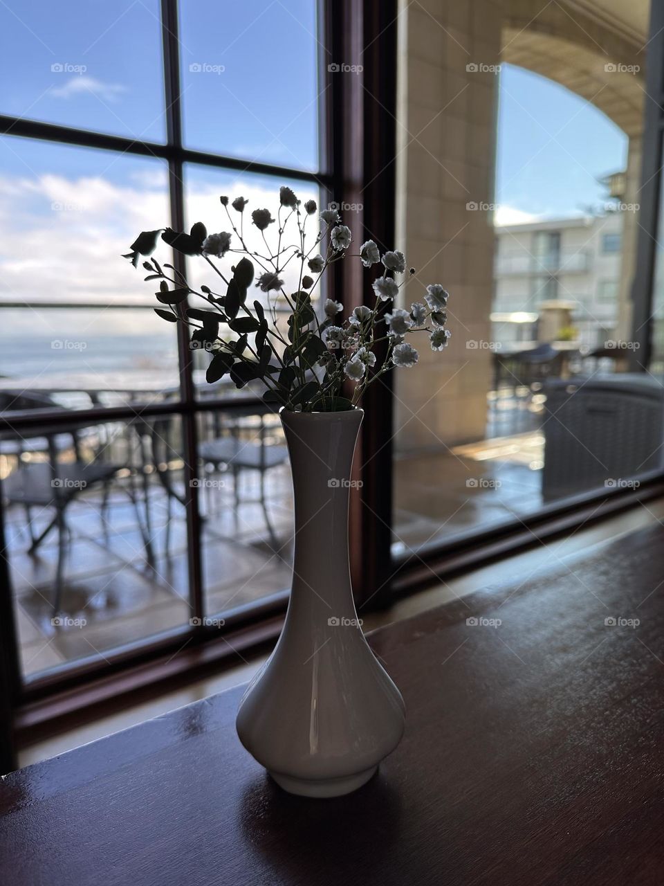 Dry flowers in a vas by the window 