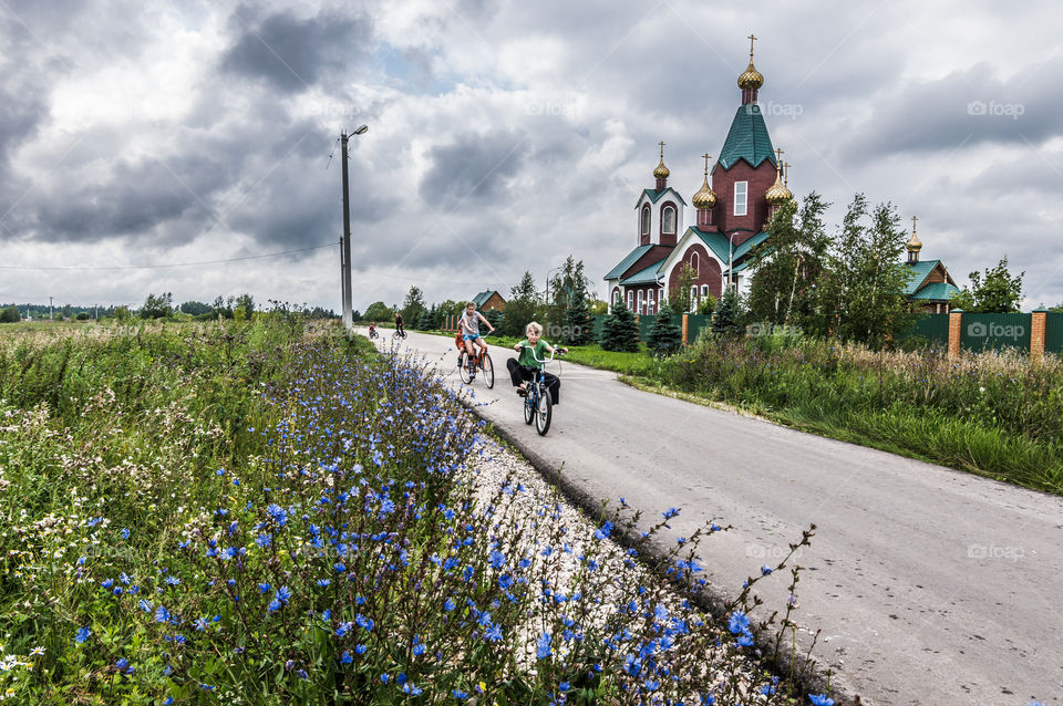 Kids riding bikes in the countryside of Russia