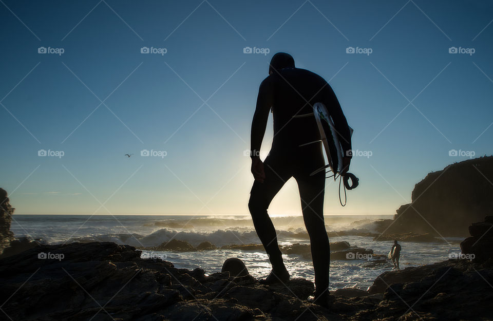 surfers entering the sea