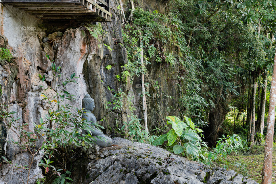 Buddha statue sitting on the rock bringing prosperity and peace