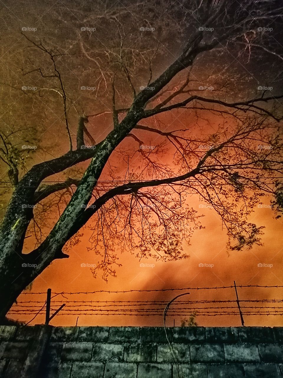 A picture showing a smoky area over the fence caused by a big fire.