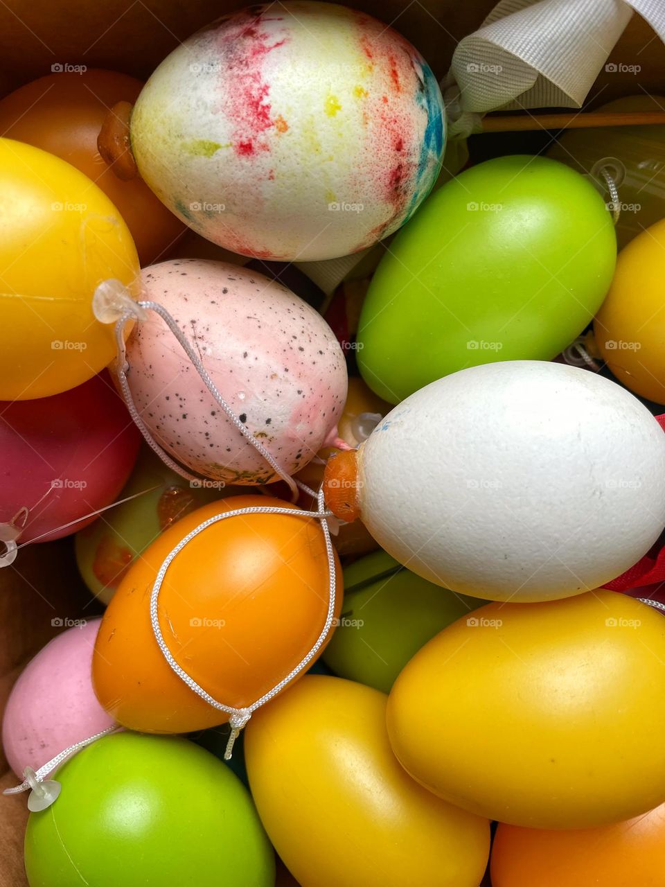 Close-up of many colorful Easter eggs in a box
