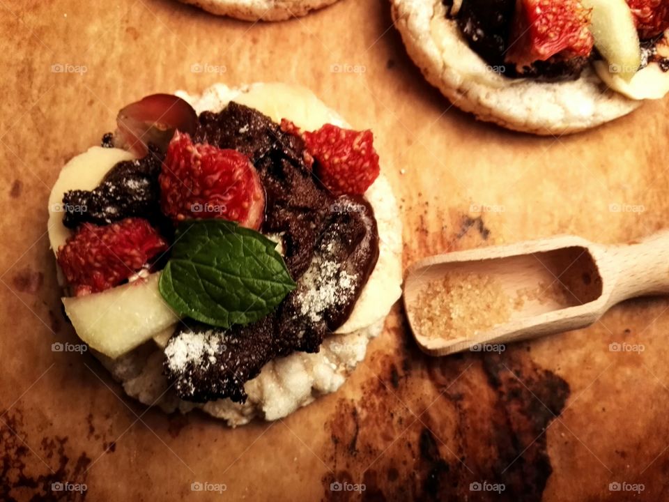 Healthy sweets with fruits and dark chocolate on a rustic background