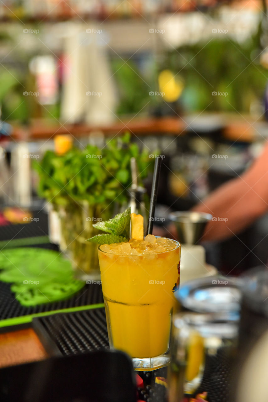Orange cocktail in drinking glass
