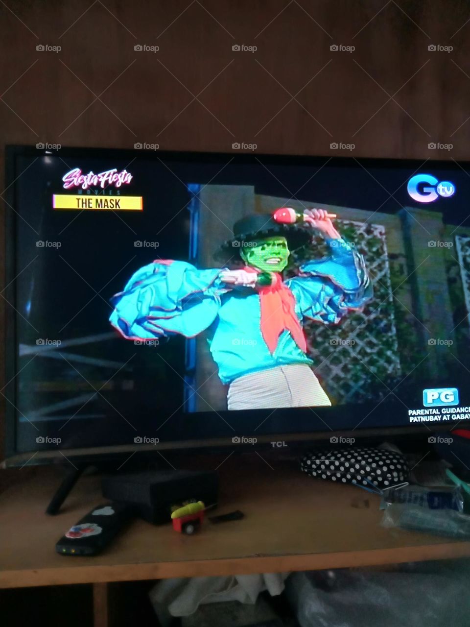 THE MASK MAN WITH A HUGE SMILE IS IN THE MOOD TO DANCE WITH MARACAS