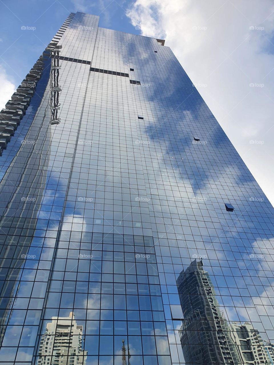 a skyscraper reflecting other skyscrapers