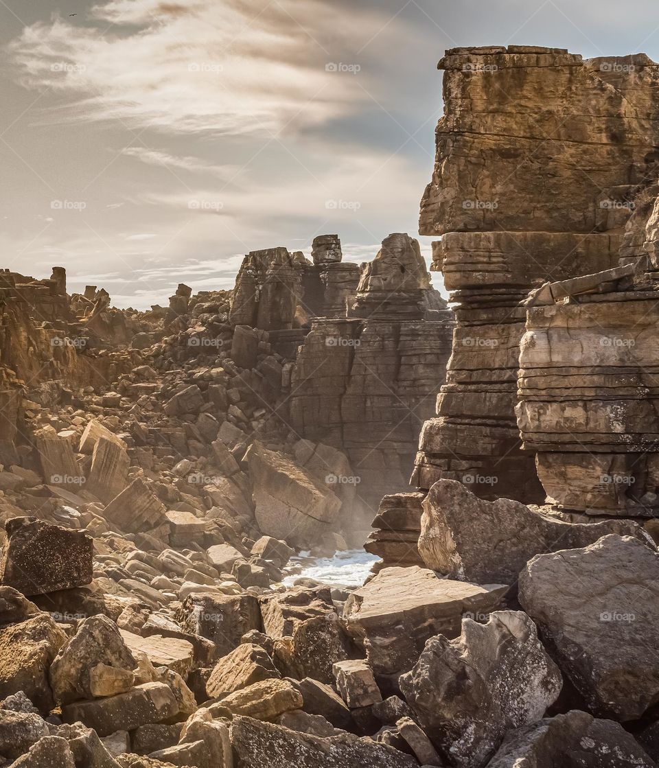 The late afternoon hazy sun, spills down the crumbling rock face down to the ocean. This isn’t the land that time forgot, but the Jurassic coastline of Peniche, Portugal 2019