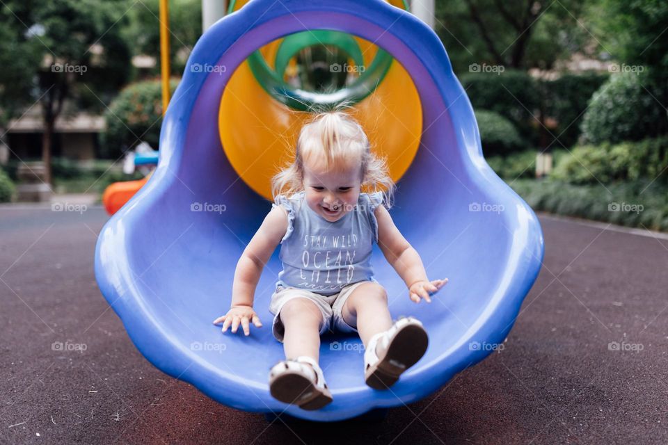 Cute baby playing on playground 