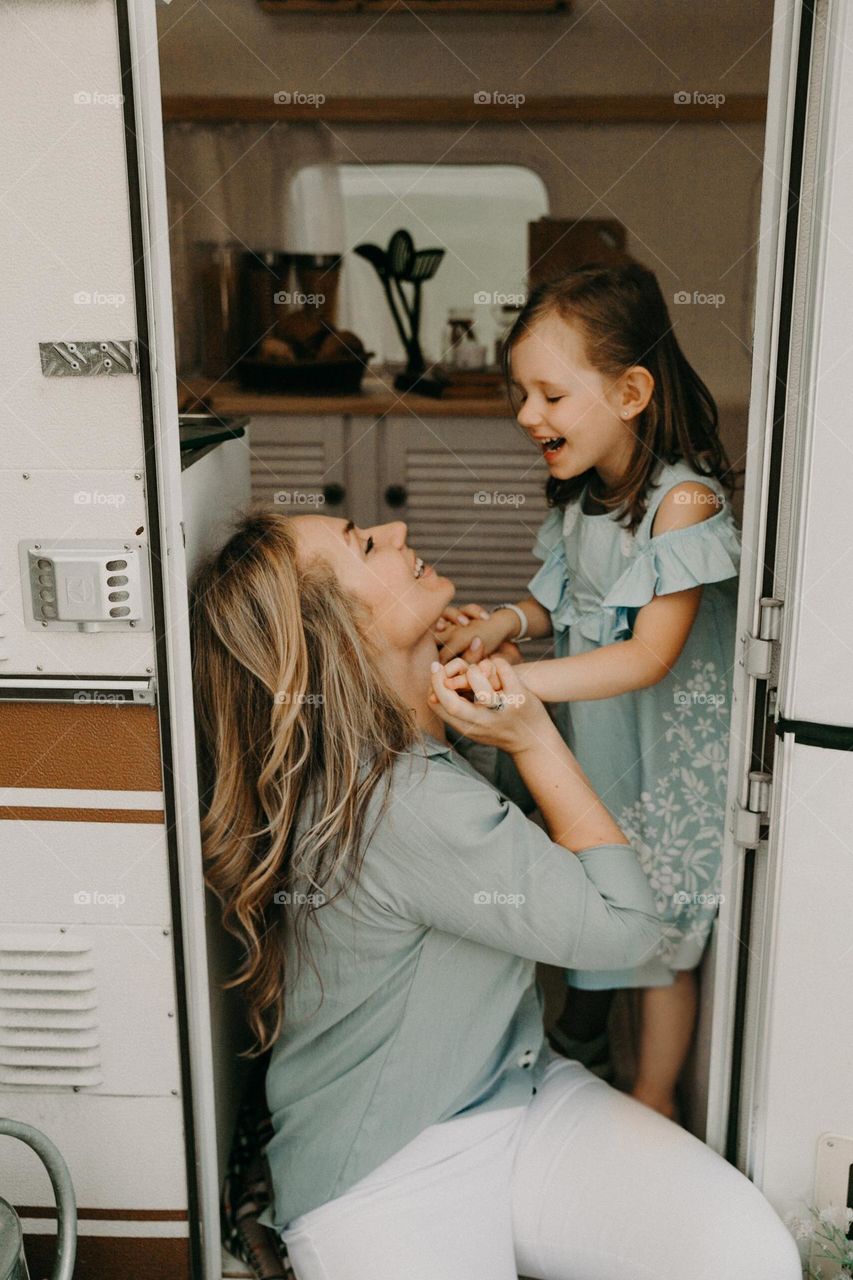 Happy mom and daughter holding hands