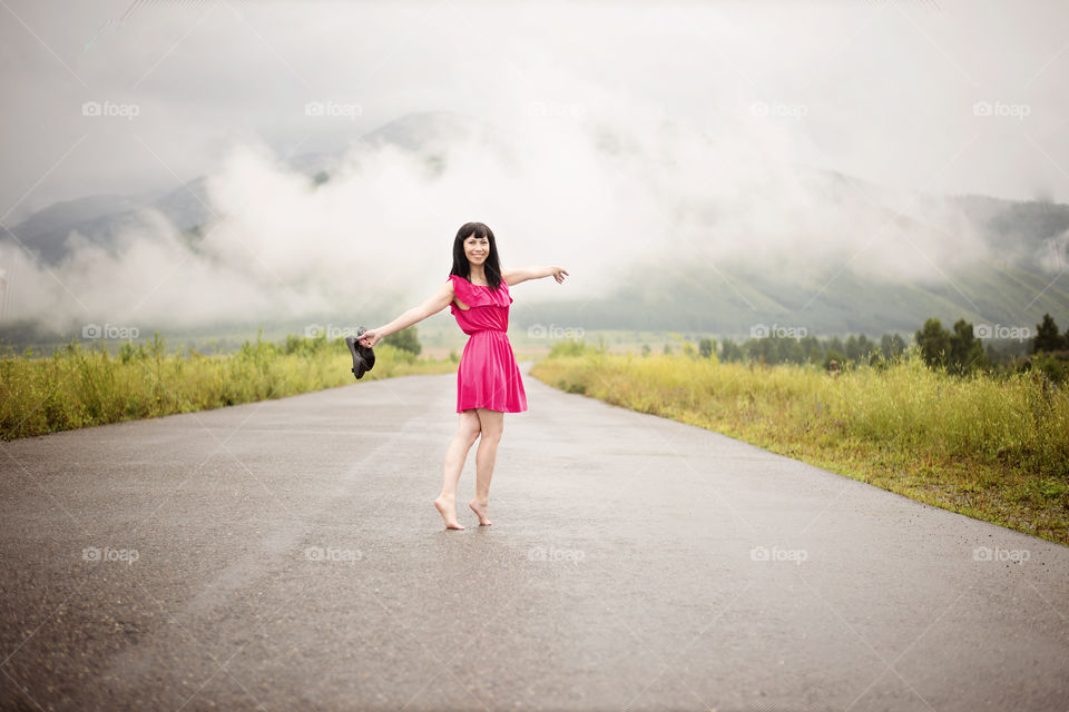 Happy asian woman on empty road