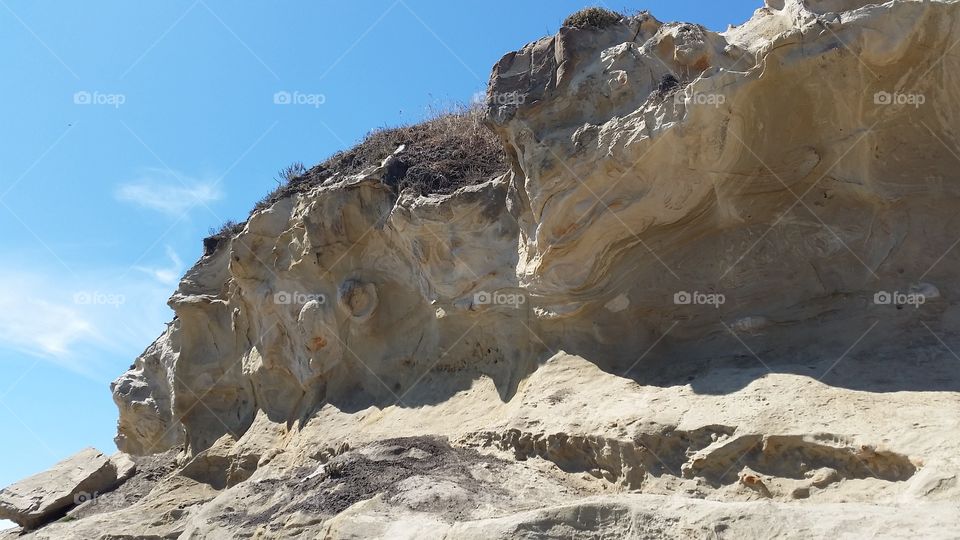 Rock with patterns. Sandstone outcropping on a beach.