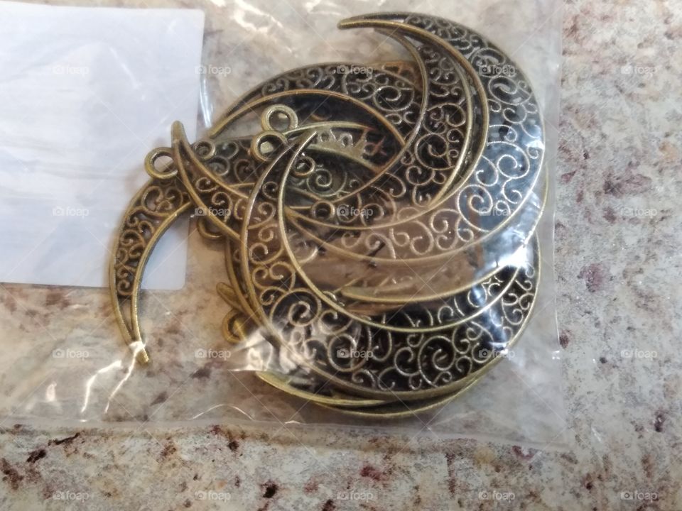 Package of crescent moon jewelry making charms