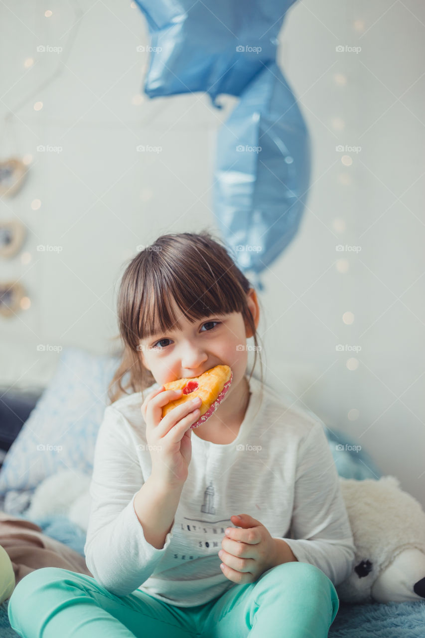 Little girl eating the donuts
