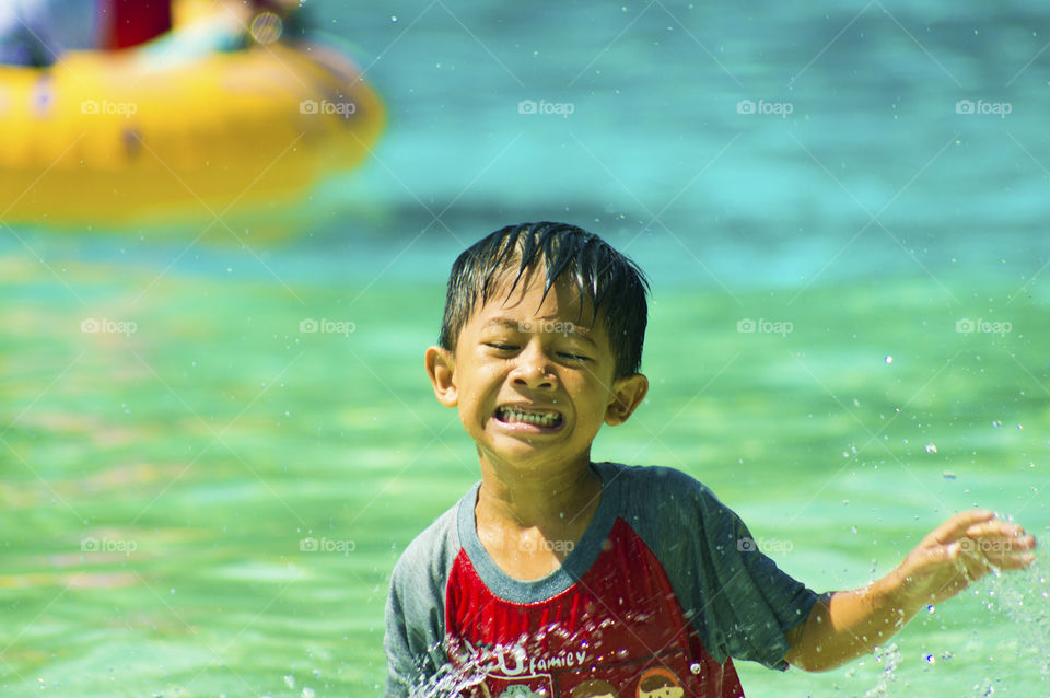 Boy crying in swimming pool