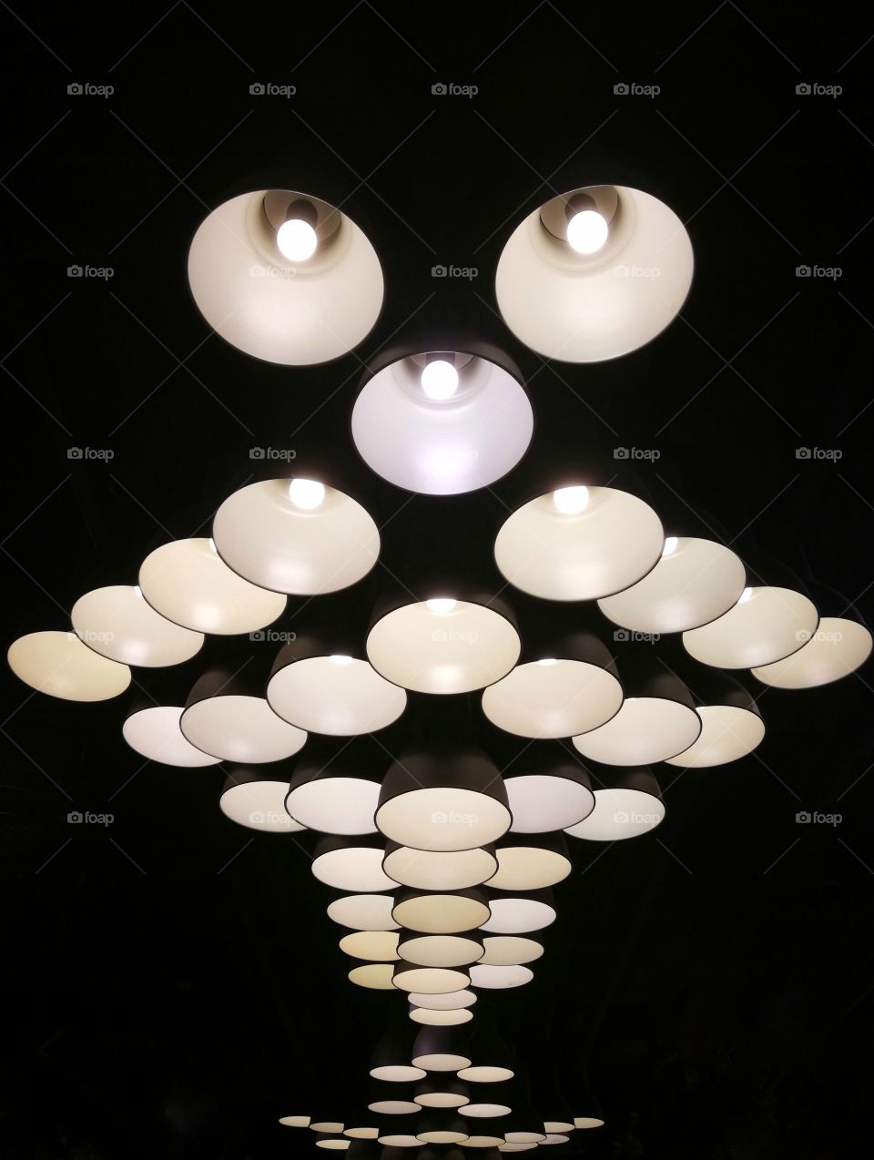 Unique pattern of group of minimalistic lighting fixtures with black background