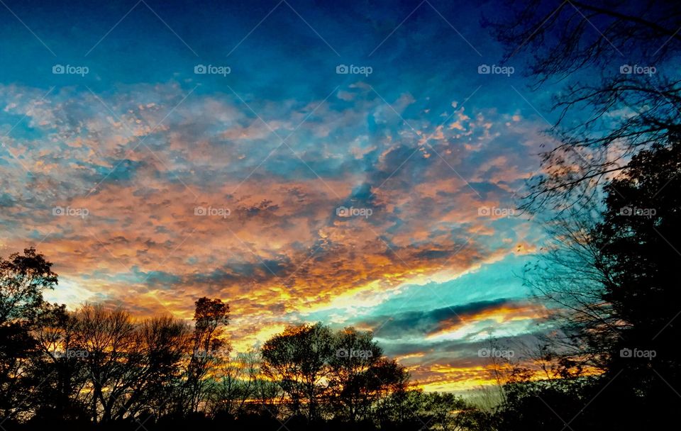 Sunset as seen from car driving on highway.