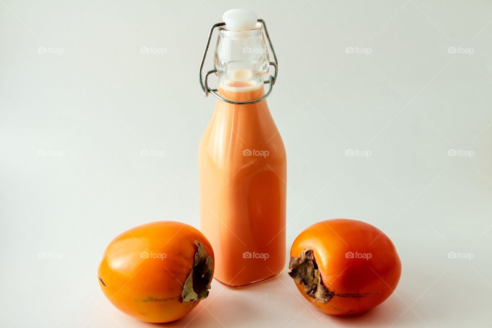 Persimmon fruits and bottle