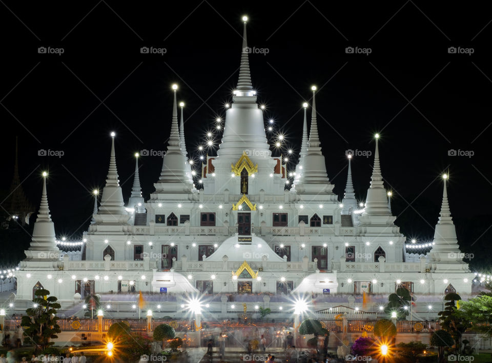 Thailand-Febuary 08 2019:Line of Monks walk around the pagoda with candle at Wat Asokkaram in Magha Puja Day is held on the Day of the full moon of the third lunar month