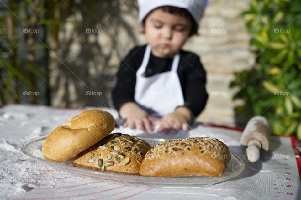 little girl chef preparing bread