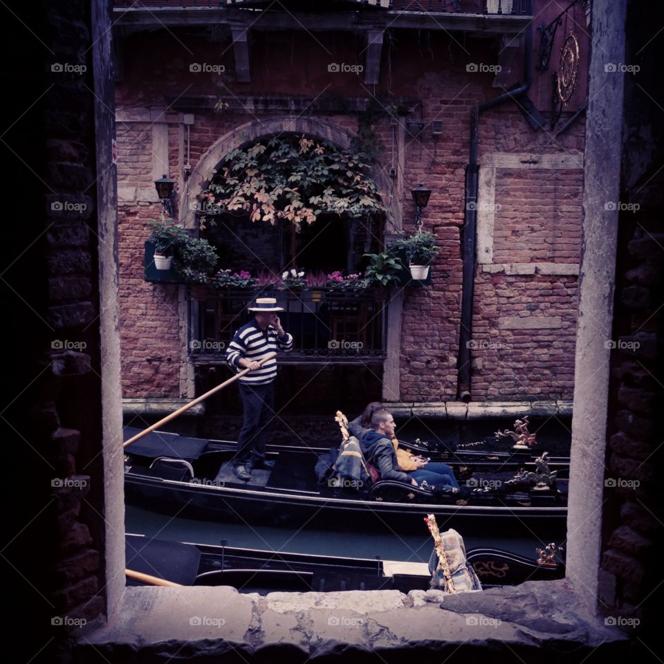 Window to Venice. Captured this perfectly timed romantic Venetian scene through the dark windows of an abandoned building. 