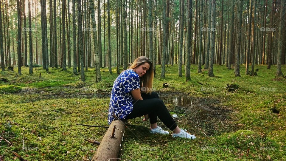 Girl posing in a green pine forest. Really nice evening shot.