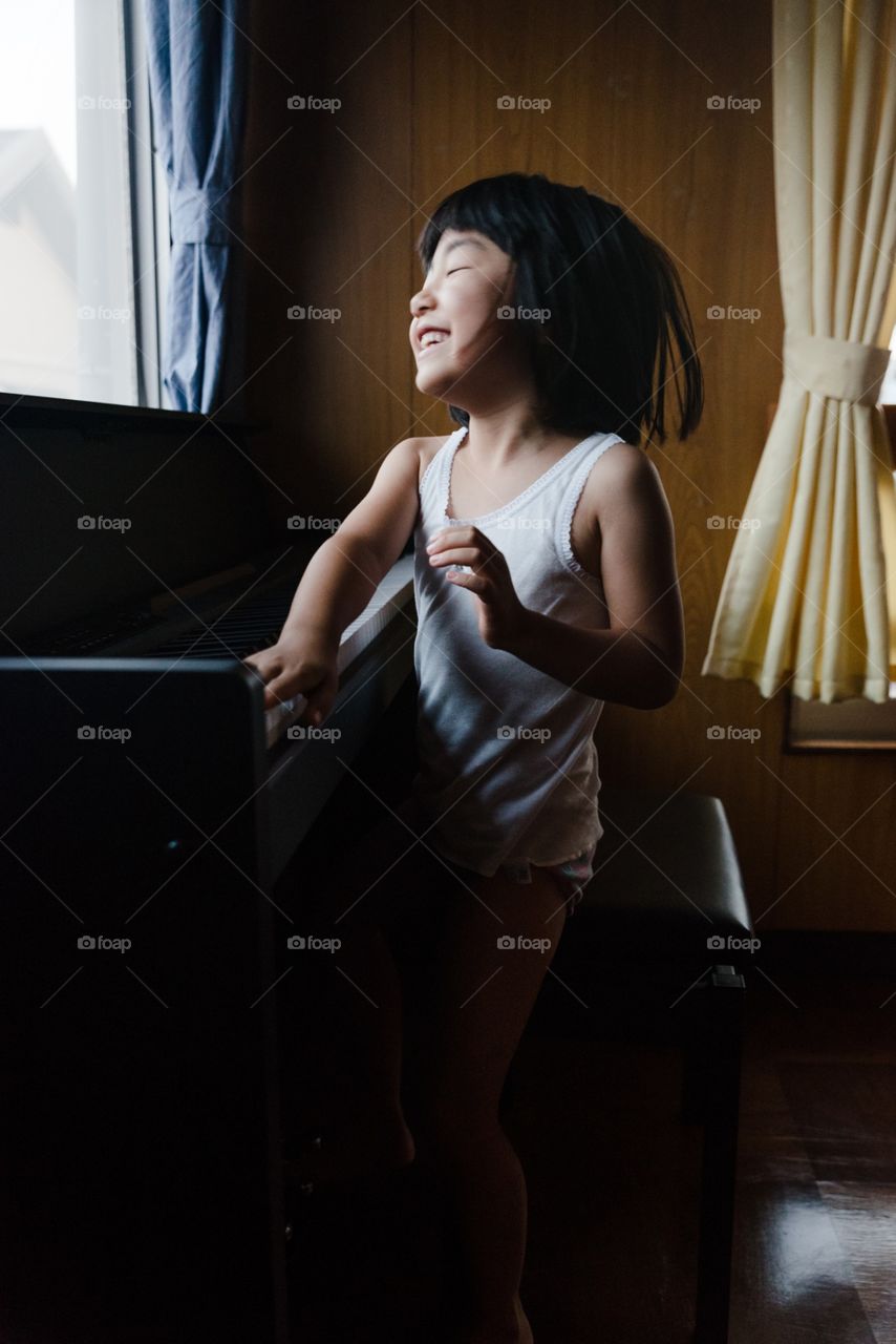 girl playing the piano