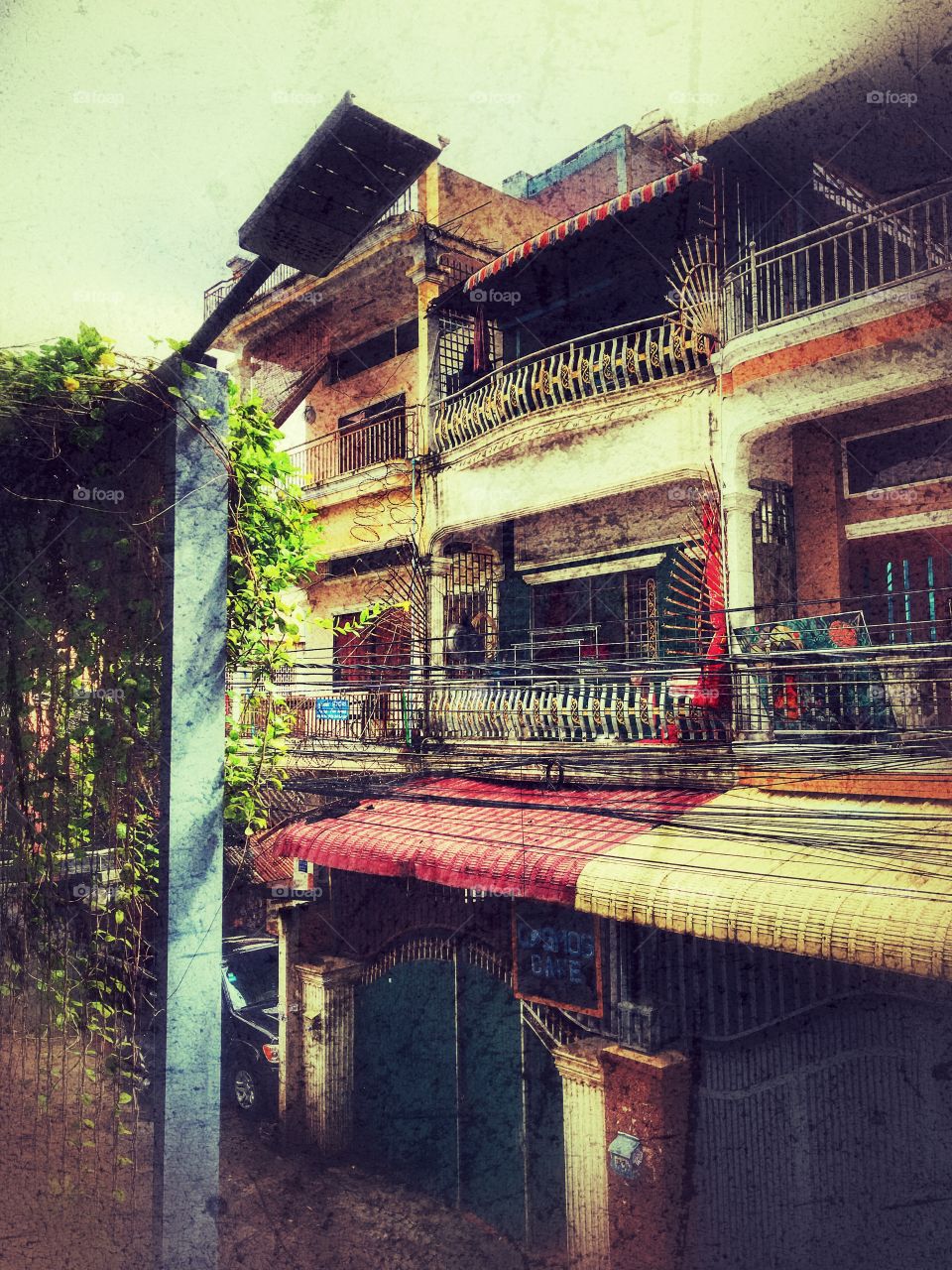 Morning In Phnom Penh... the bright sunlight over the old quarter of the city.  The colorful terraces glow