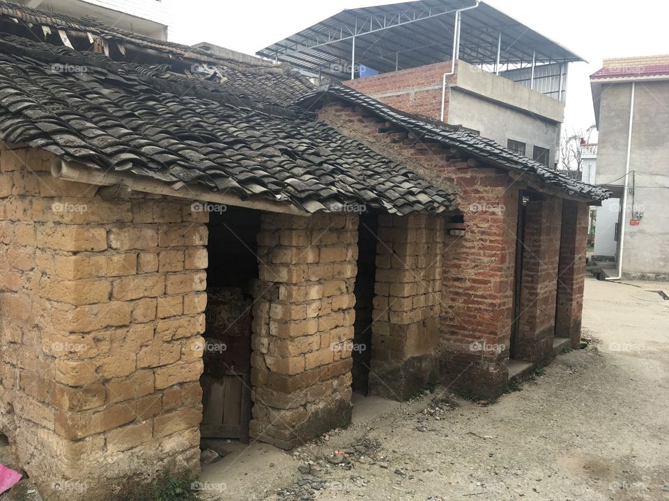 Public toilets made of mud bricks in Fu Li village, Guilin, China.