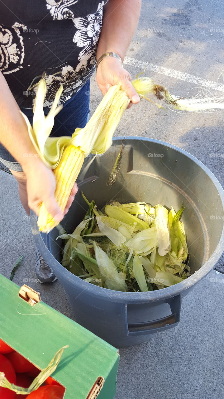 woman peeling corn