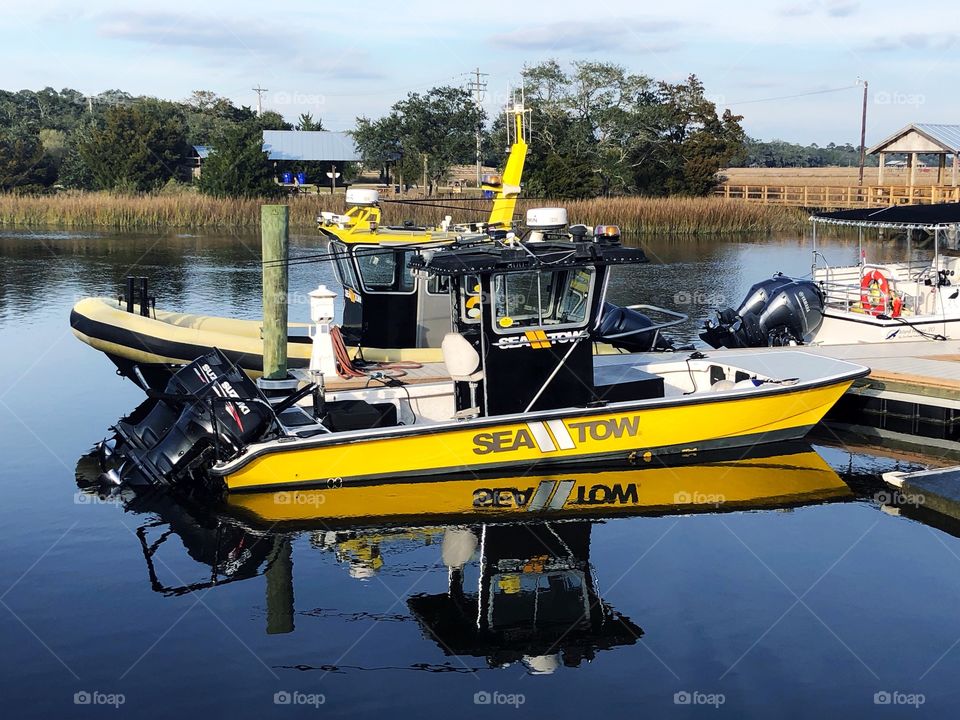 A Se Tow boat reflecting on Shem Creek in Charleston South Carolina.