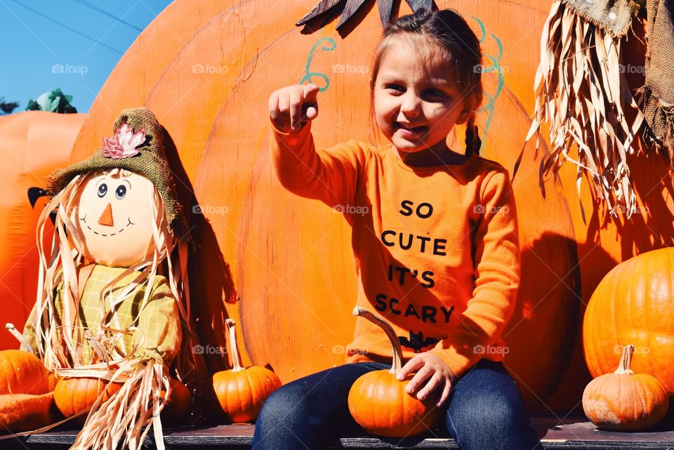 Portrait of girl holding pumpkin