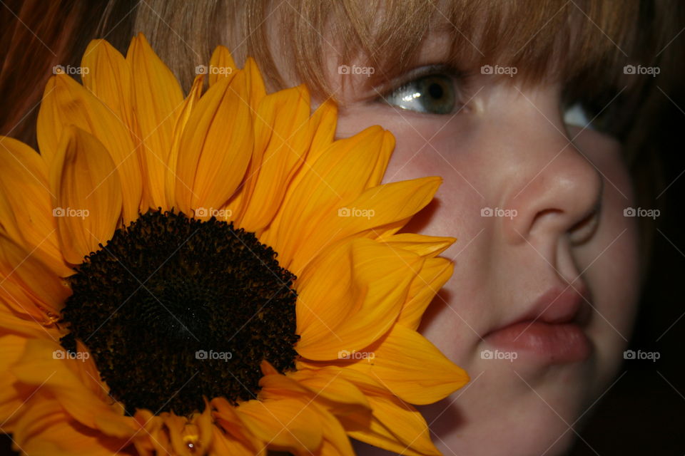 Cute little girl with sunflower
