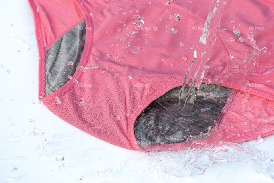 Water splashing onto pink underwear