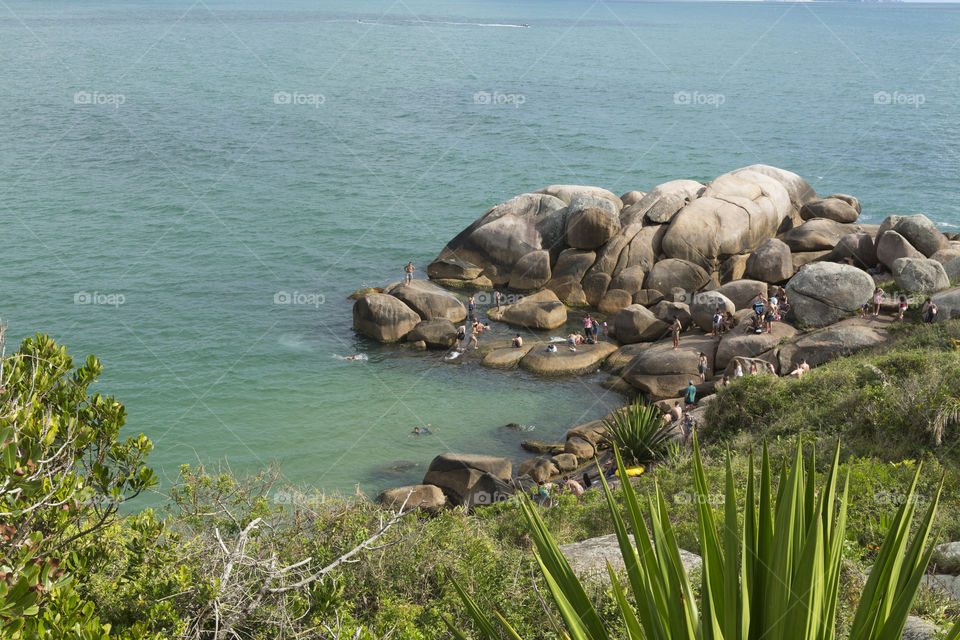 Tourists enjoy the summer in natural pools in Barra da Lagoa in Florianopolis Santa Catarina Brazil.