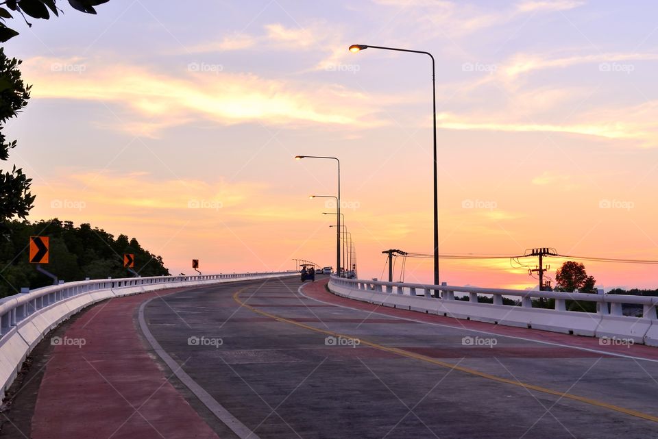 Travel on the road curve and sunset background