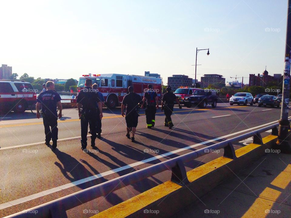 Firefighters in action. Firefighters in action on the bridge of Boston on Sunset