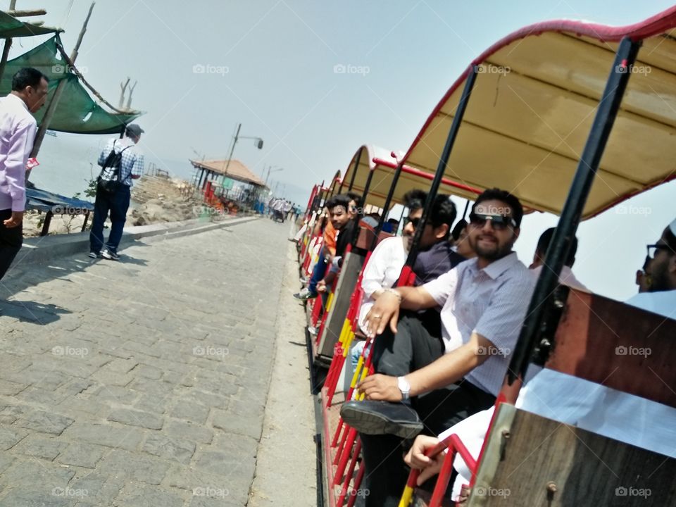 Group of tourists on tram at park