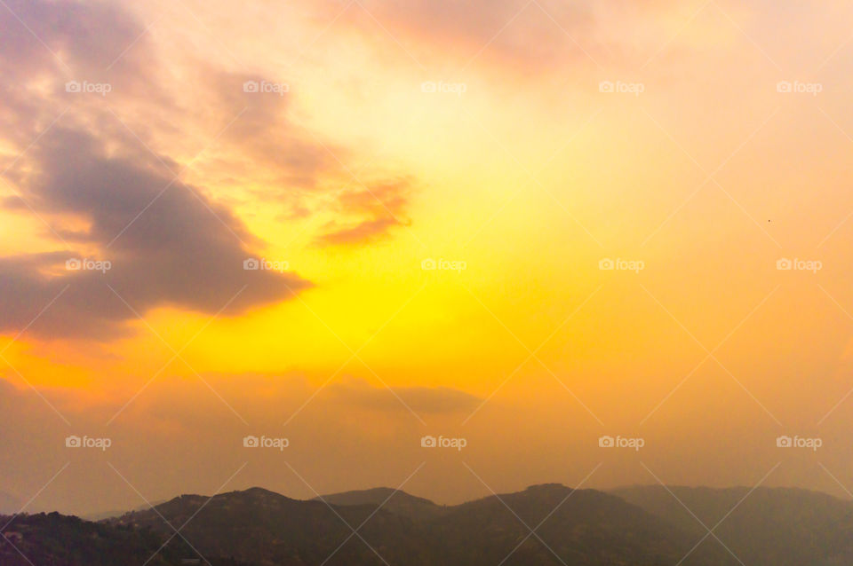 Photograph of vibrant cloudy sky at dusk dawn daytime snap in landscape style. Useful for background wallpaper screen saver e-cards website to decorate interior. Travel, Vacation, freedom, simplicity Holiday Concept. Subject is inspiration hopeful br
