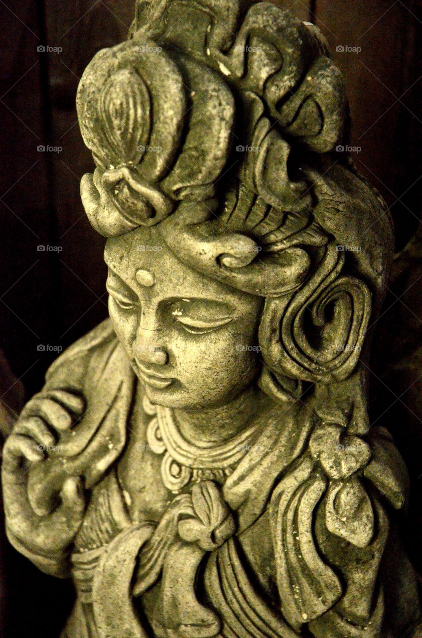 Kwan Yin,  I believe.   Garden Statue.