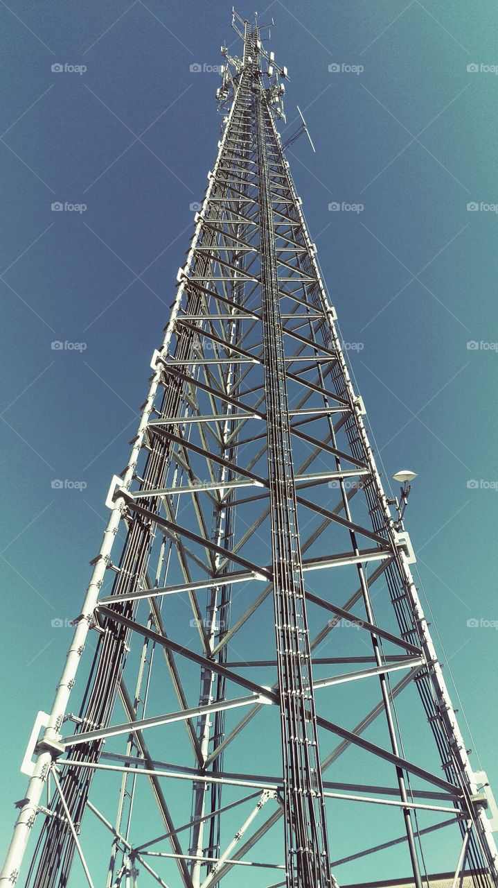 Telecommunication tower antenna against sky