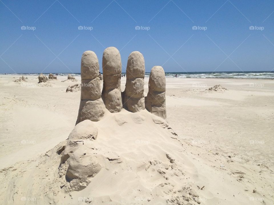 Four fingers in the sand 